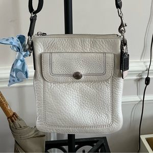 White leather crossbody Coach bag with adjustable straps, side back zipper